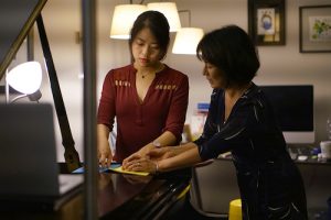 Pei-Chen Chen is guided by Professor Midori Koga in the hand movements that are part of the PBT warm-up for pianists.